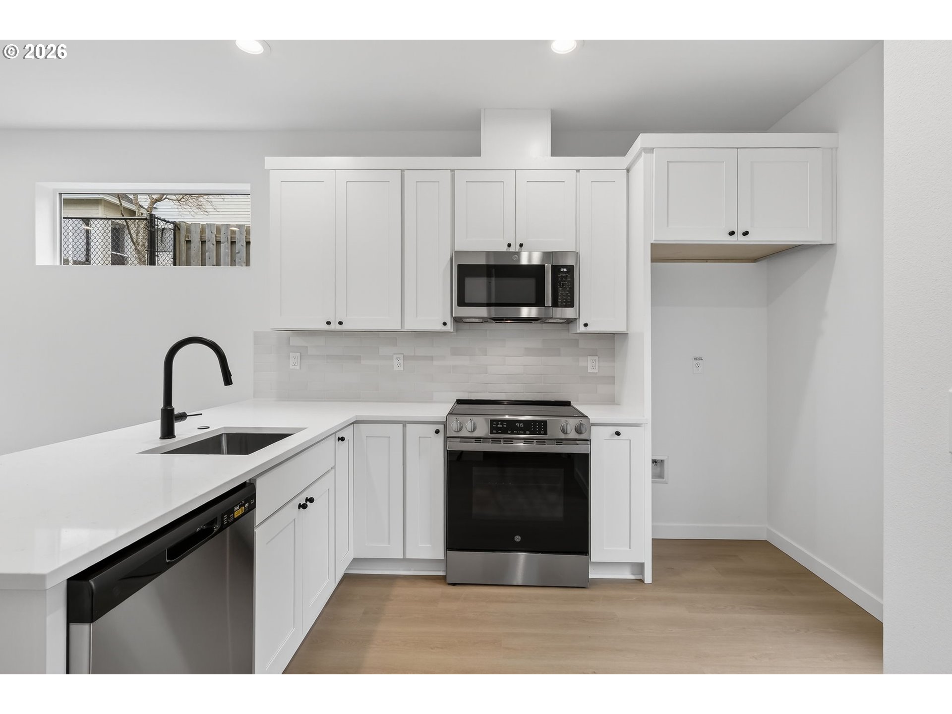 4059 Southwest McKinley Street, Unit 40 Gresham, OR 97080 - Photo 14 of 39 a kitchen with stainless steel appliances granite countertop a stove a sink and a refrigerator