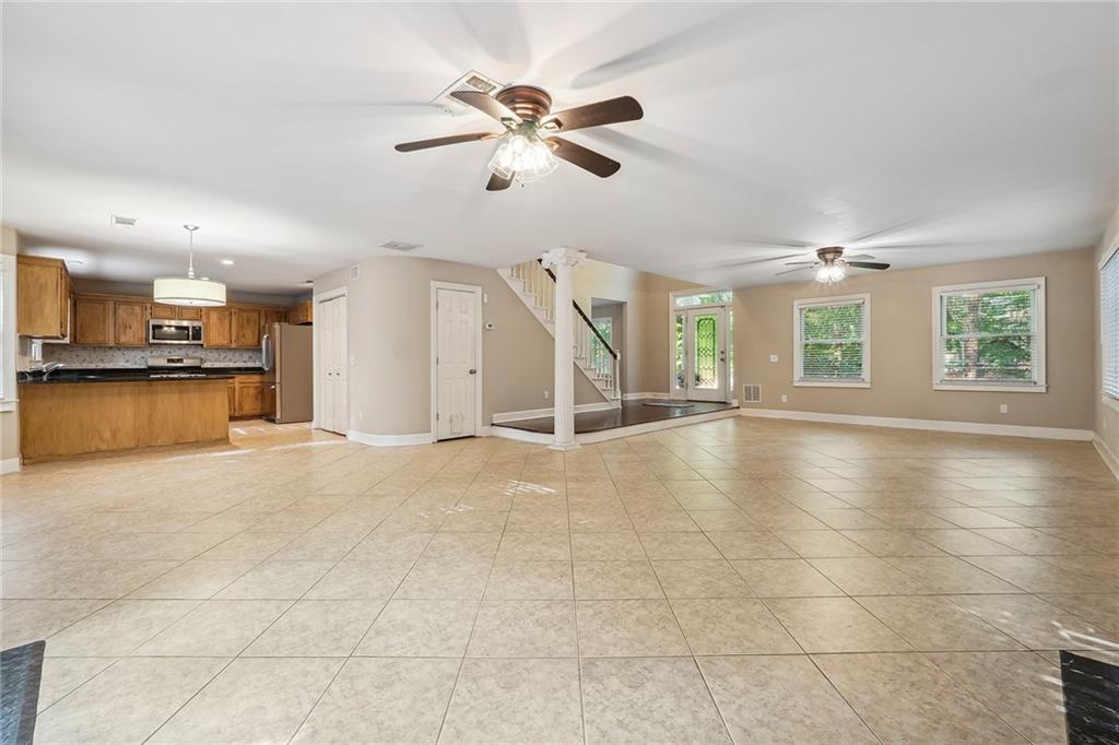 515 Spring Gate Lane Alpharetta, GA 30009 - Photo 12 of 36 a view of an empty room with a window and kitchen view