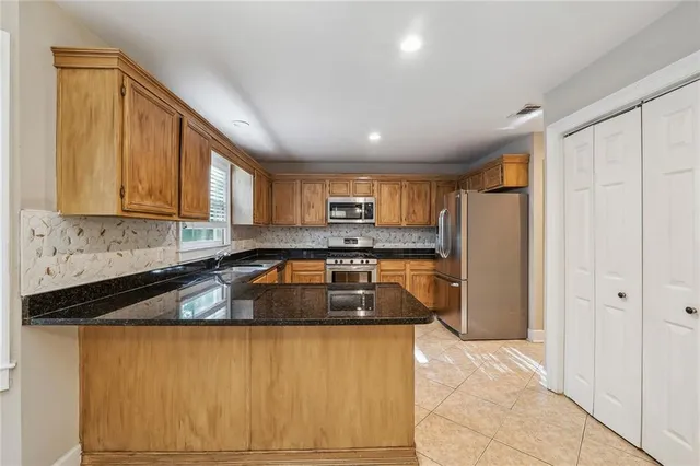 a kitchen with a sink and a stove top oven