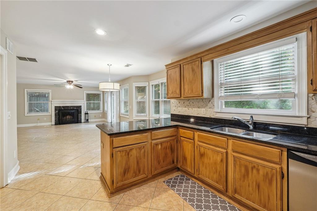 515 Spring Gate Lane Alpharetta, GA 30009 - Photo 16 of 36 a kitchen with a sink and a stove top oven