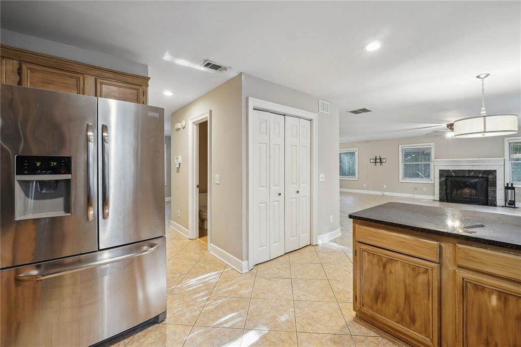 515 Spring Gate Lane Alpharetta, GA 30009 - Photo 17 of 36 a kitchen with granite countertop a refrigerator and a sink