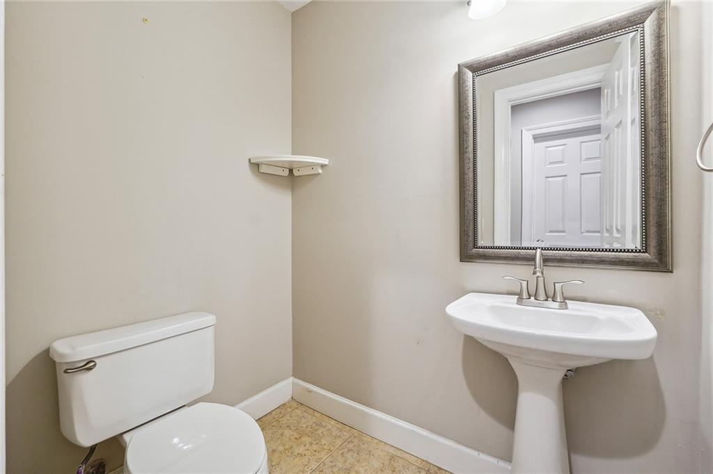 515 Spring Gate Lane Alpharetta, GA 30009 - Photo 18 of 36 a bathroom with a toilet sink and mirror