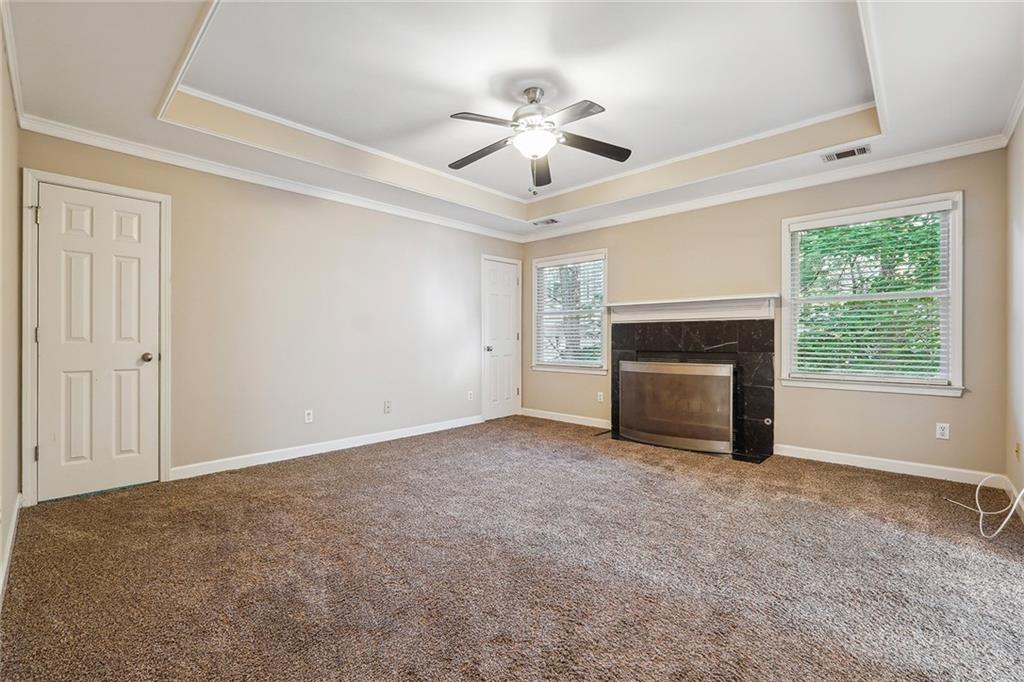 515 Spring Gate Lane Alpharetta, GA 30009 - Photo 19 of 36 a view of empty room with fireplace and windows