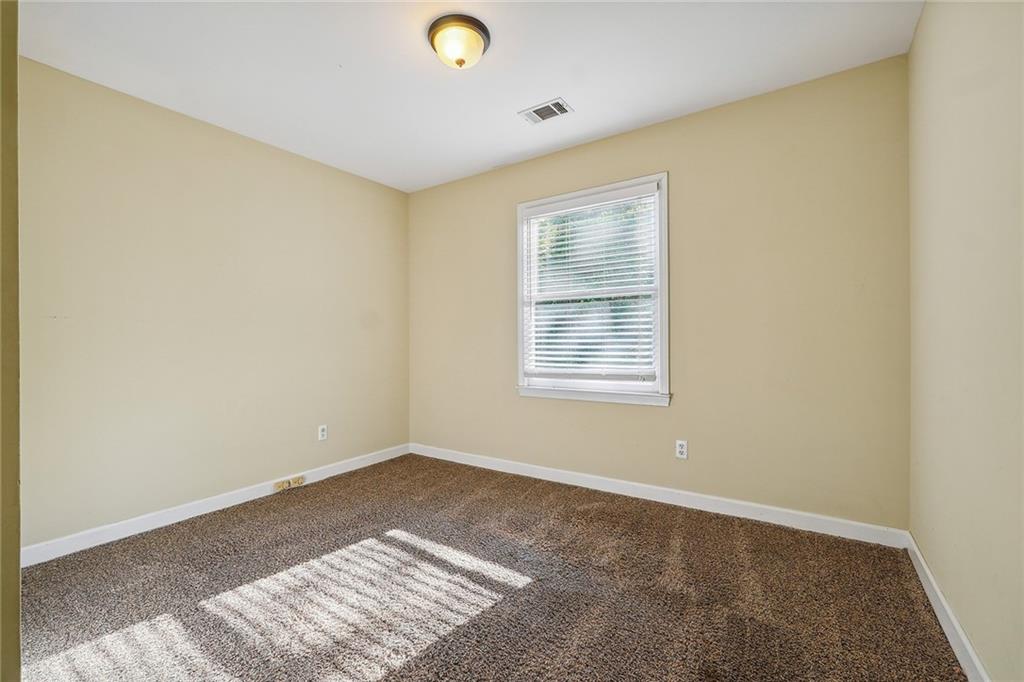 515 Spring Gate Lane Alpharetta, GA 30009 - Photo 22 of 36 an empty room with a window