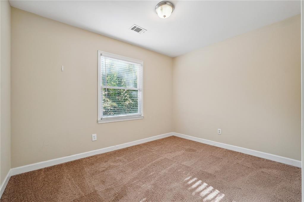 515 Spring Gate Lane Alpharetta, GA 30009 - Photo 23 of 36 an empty room with a window