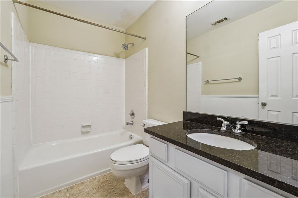 515 Spring Gate Lane Alpharetta, GA 30009 - Photo 25 of 36 a bathroom with a granite countertop sink toilet and shower