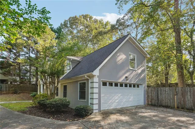 front view of house with a potted plant windows