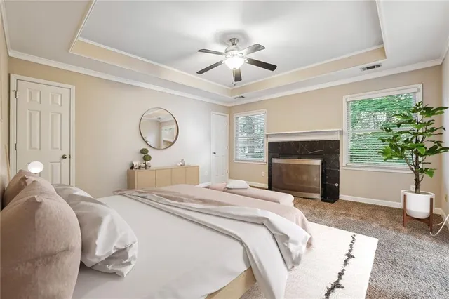 a spacious bedroom with a bed and a fireplace