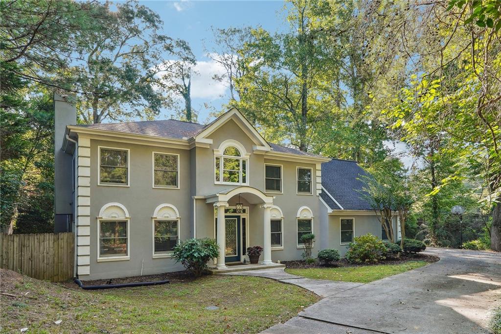 515 Spring Gate Lane Alpharetta, GA 30009 - Photo 6 of 36 a front view of a house with garden