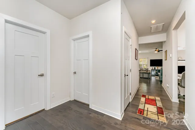 wooden floor with view of living room