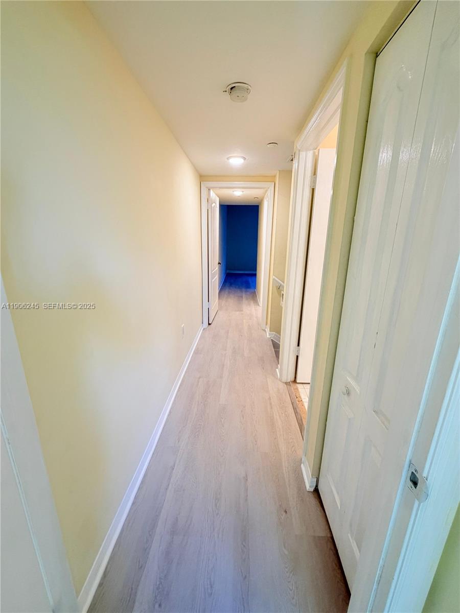 12635 Southwest 91st Street, Unit 211 Miami, FL 33186 - Photo 6 of 16 a view of a hallway with wooden floor