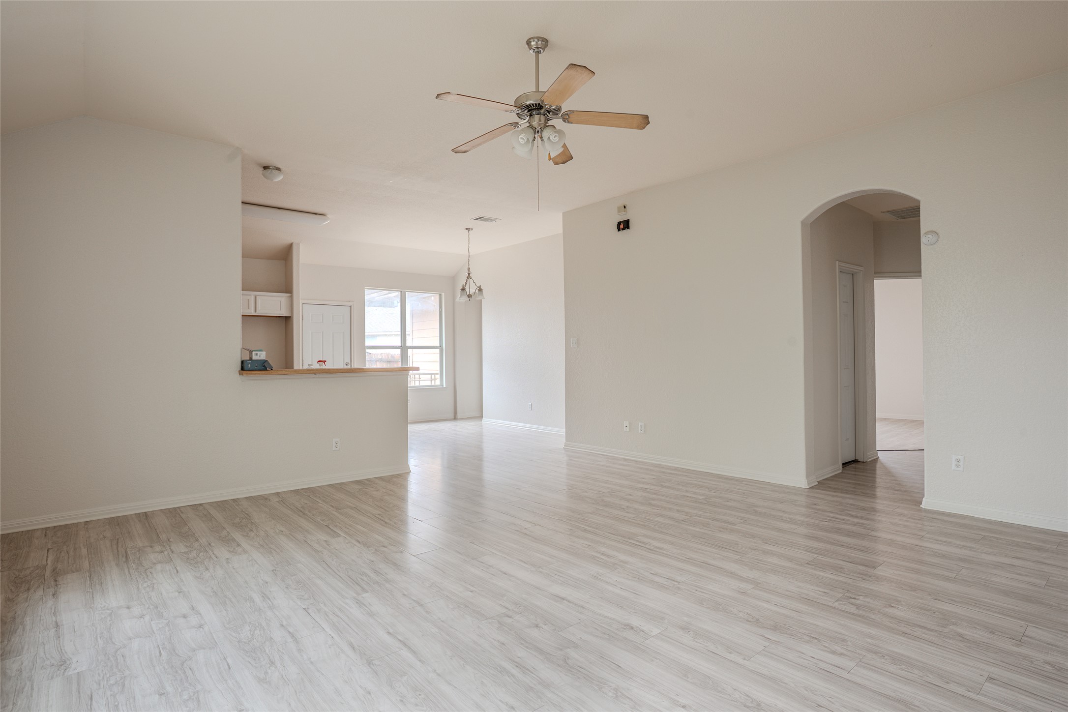 140 Dropper Kyle, TX 78640 - Photo 11 of 30 a view of an empty room with a window and wooden floor