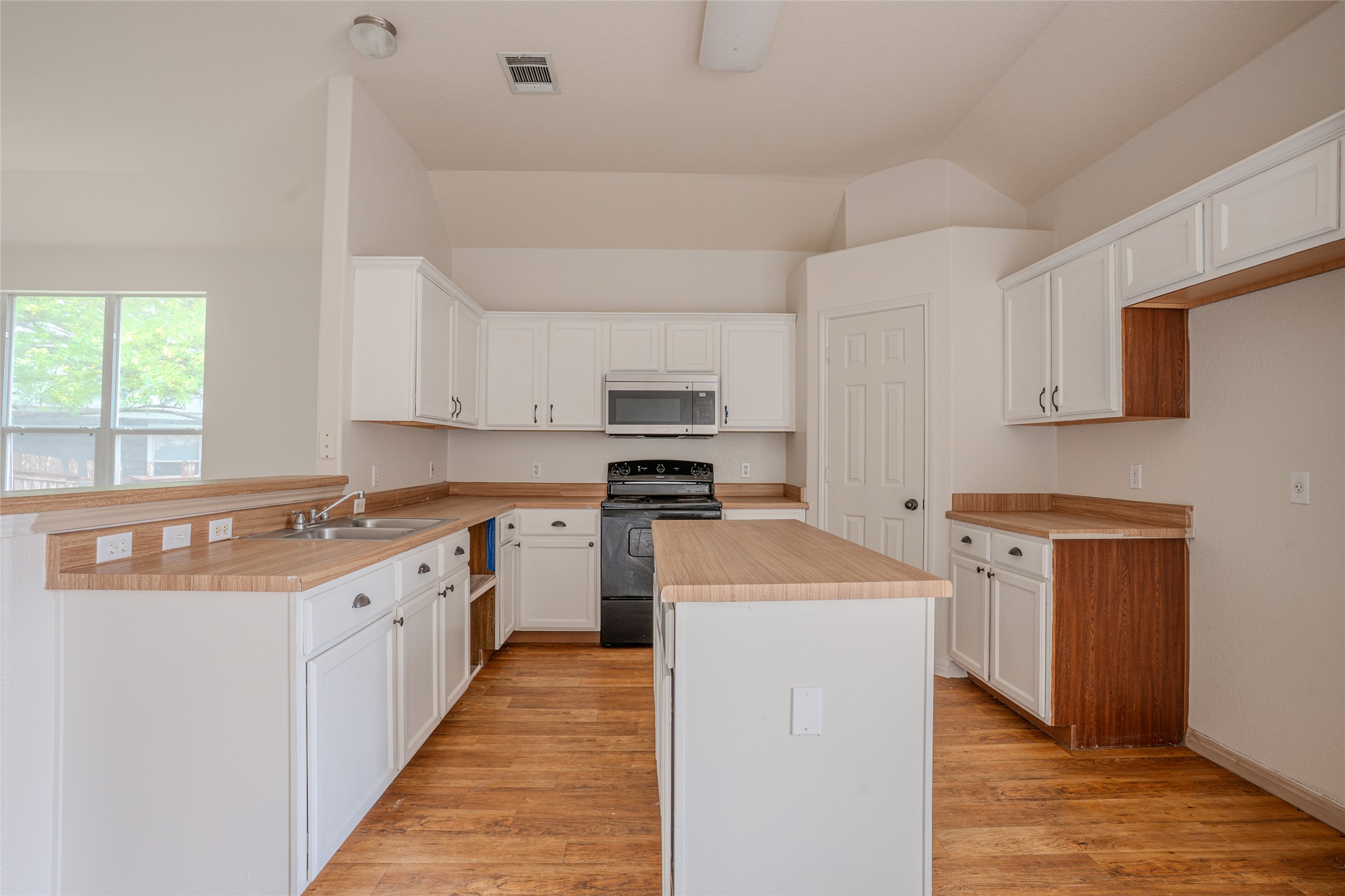 140 Dropper Kyle, TX 78640 - Photo 13 of 30 a kitchen with cabinets appliances a sink and a window