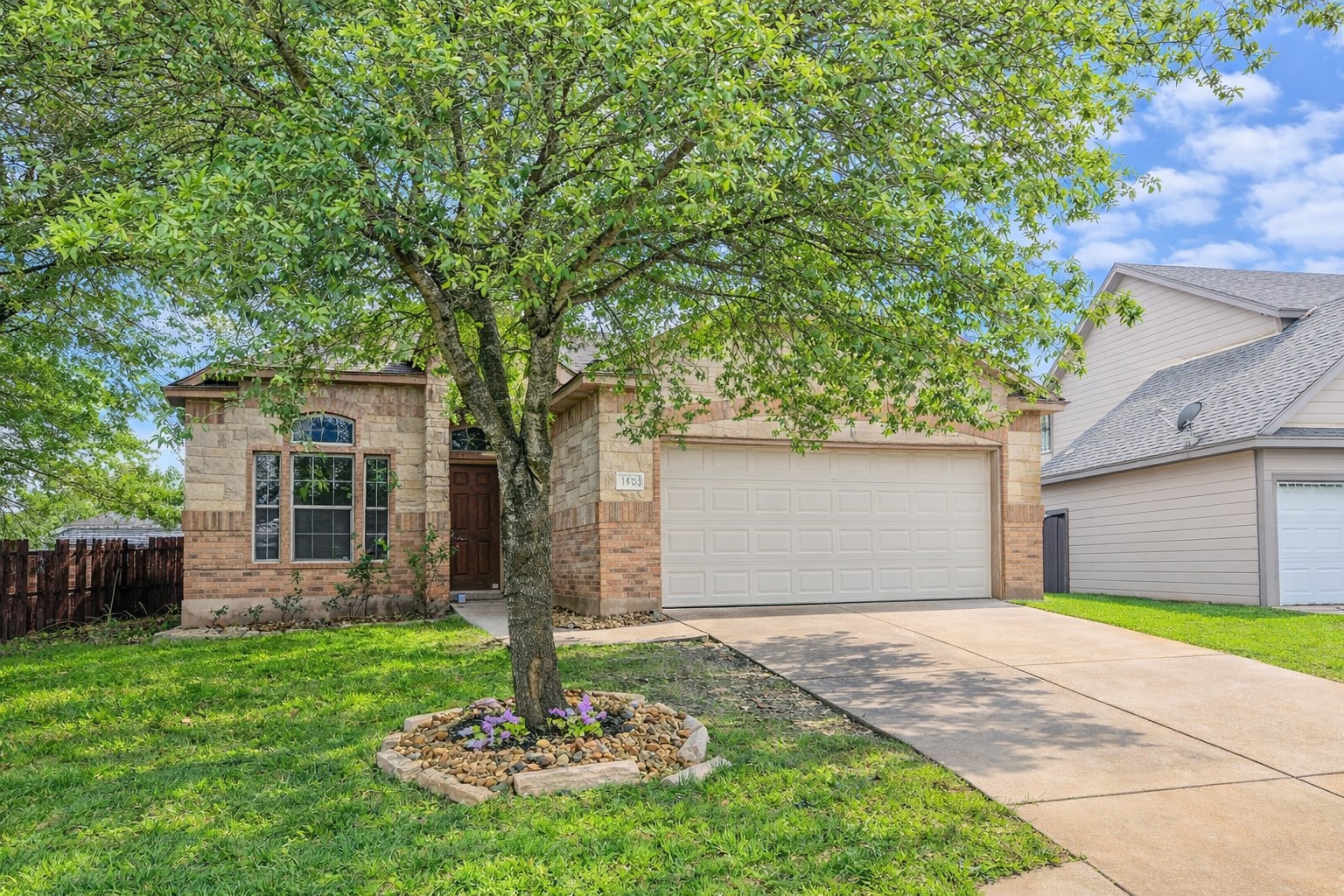 140 Dropper Kyle, TX 78640 - Photo 2 of 30 a front view of a house with a yard and garage