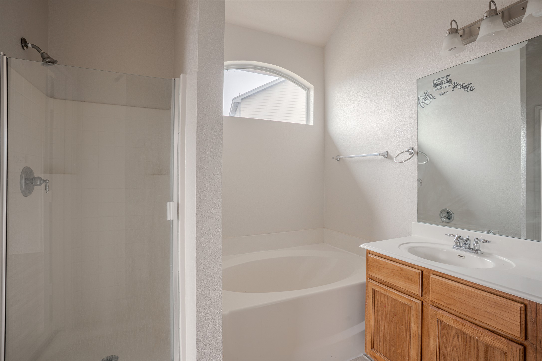 140 Dropper Kyle, TX 78640 - Photo 21 of 30 a bathroom with a bathtub shower sink vanity and a toilet