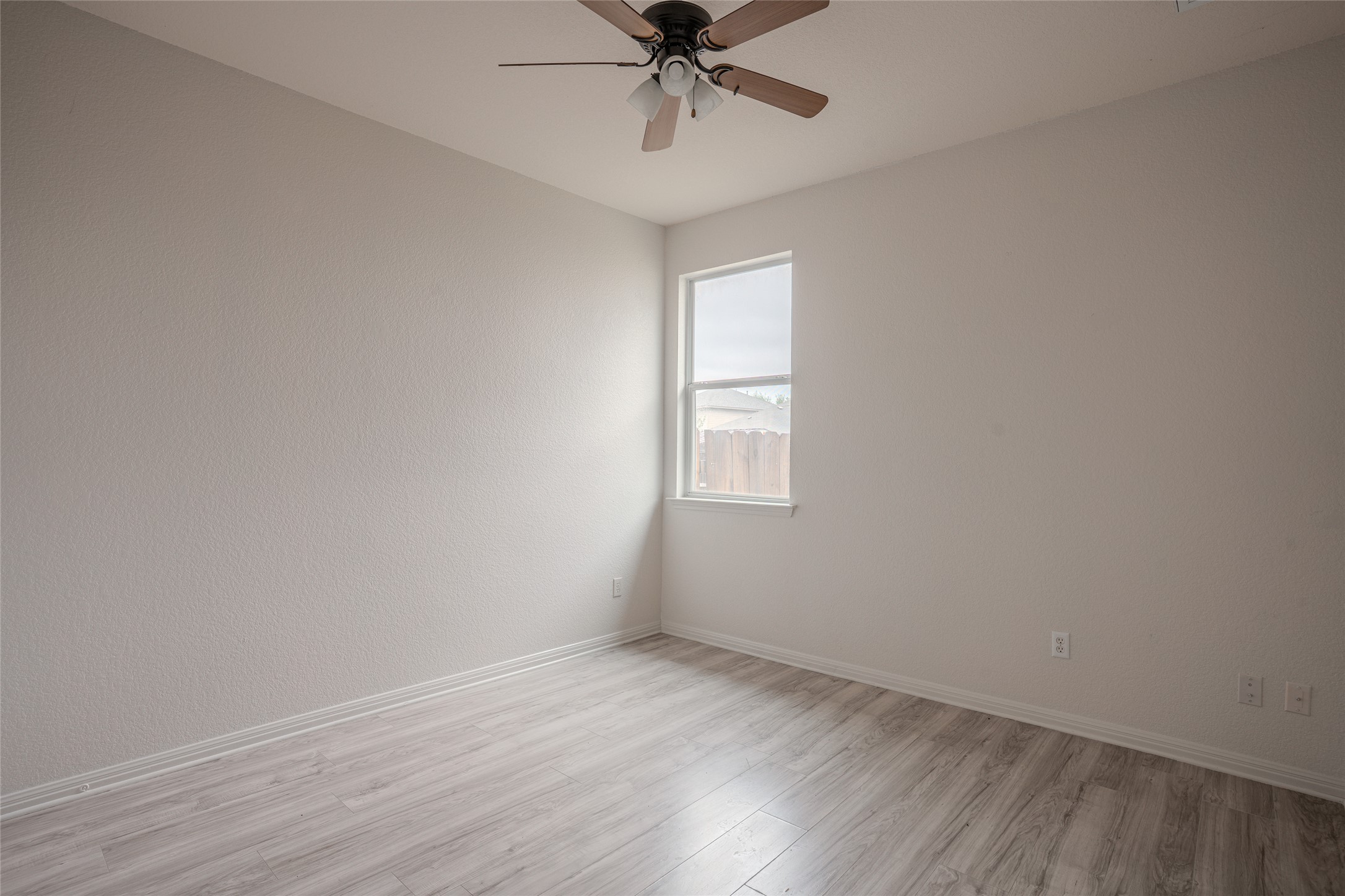 140 Dropper Kyle, TX 78640 - Photo 22 of 30 wooden floor in an empty room with a window