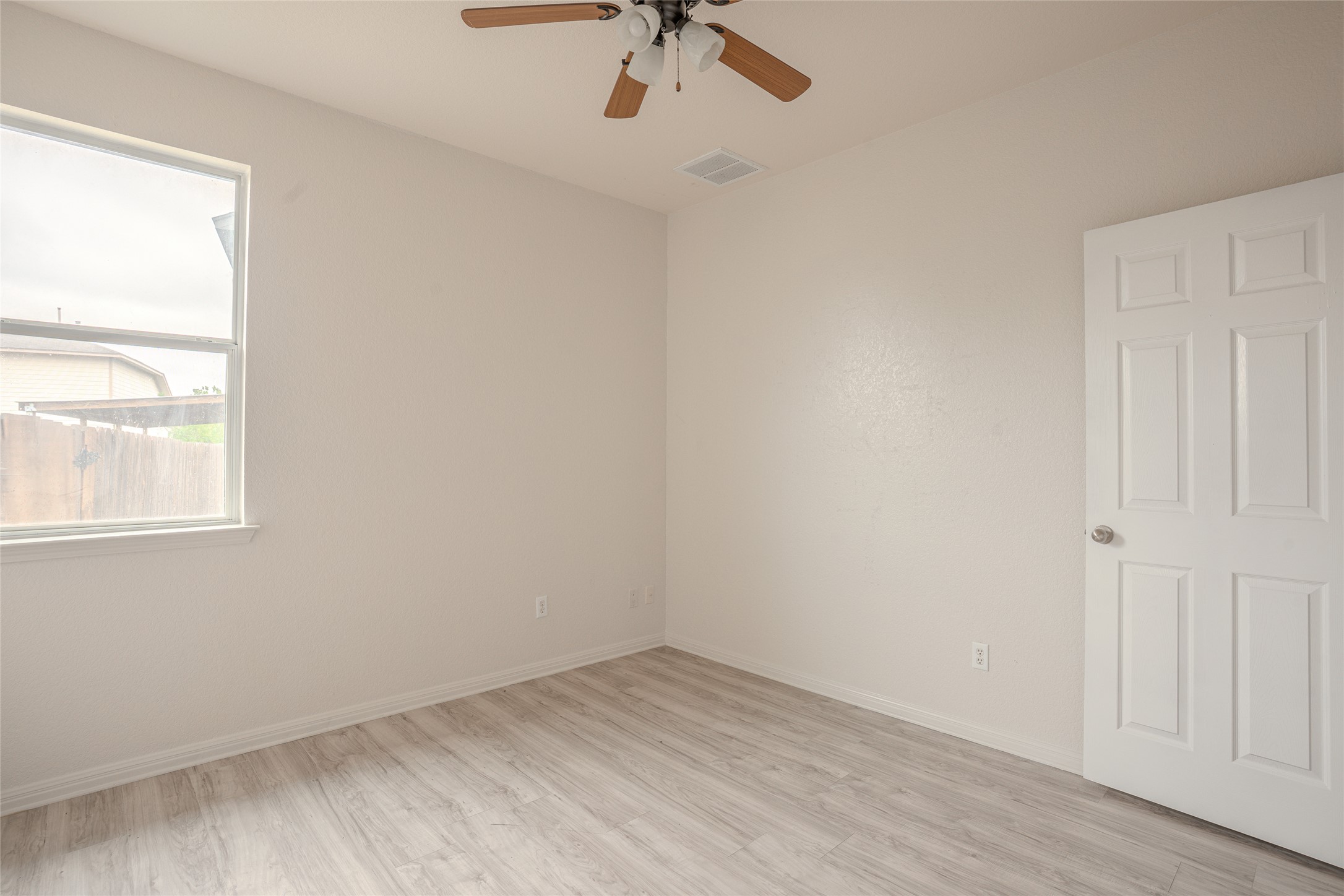 140 Dropper Kyle, TX 78640 - Photo 23 of 30 an empty room with a window and a ceiling fan