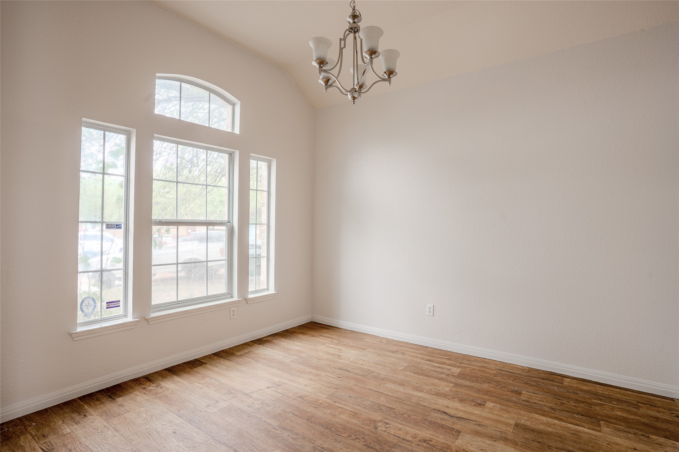 140 Dropper Kyle, TX 78640 - Photo 8 of 30 a view of an empty room with wooden floor and windows