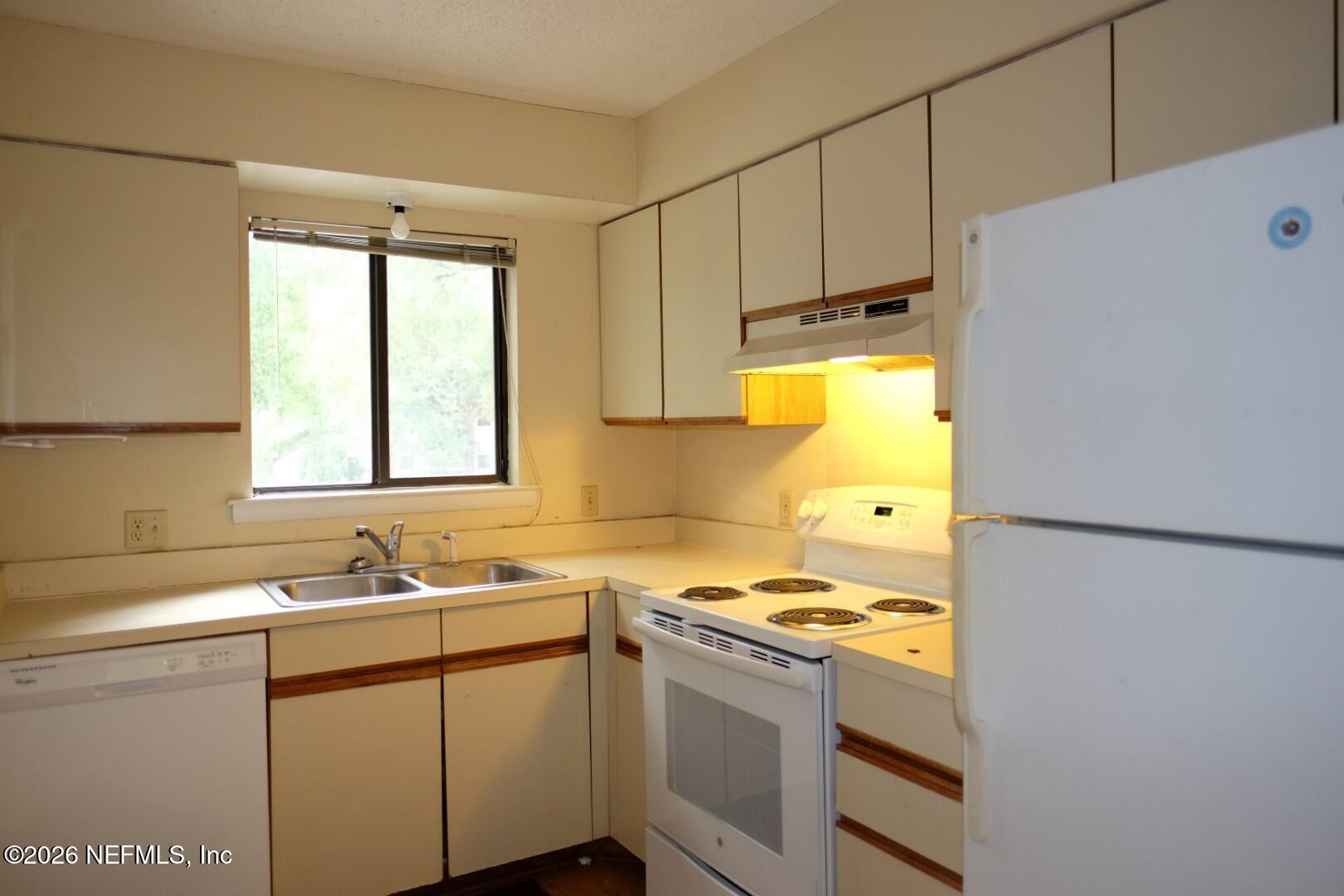 2328 Sadler Road, Unit 7D Fernandina Beach, FL 32034 - Photo 2 of 7 a kitchen with a sink a stove and a refrigerator