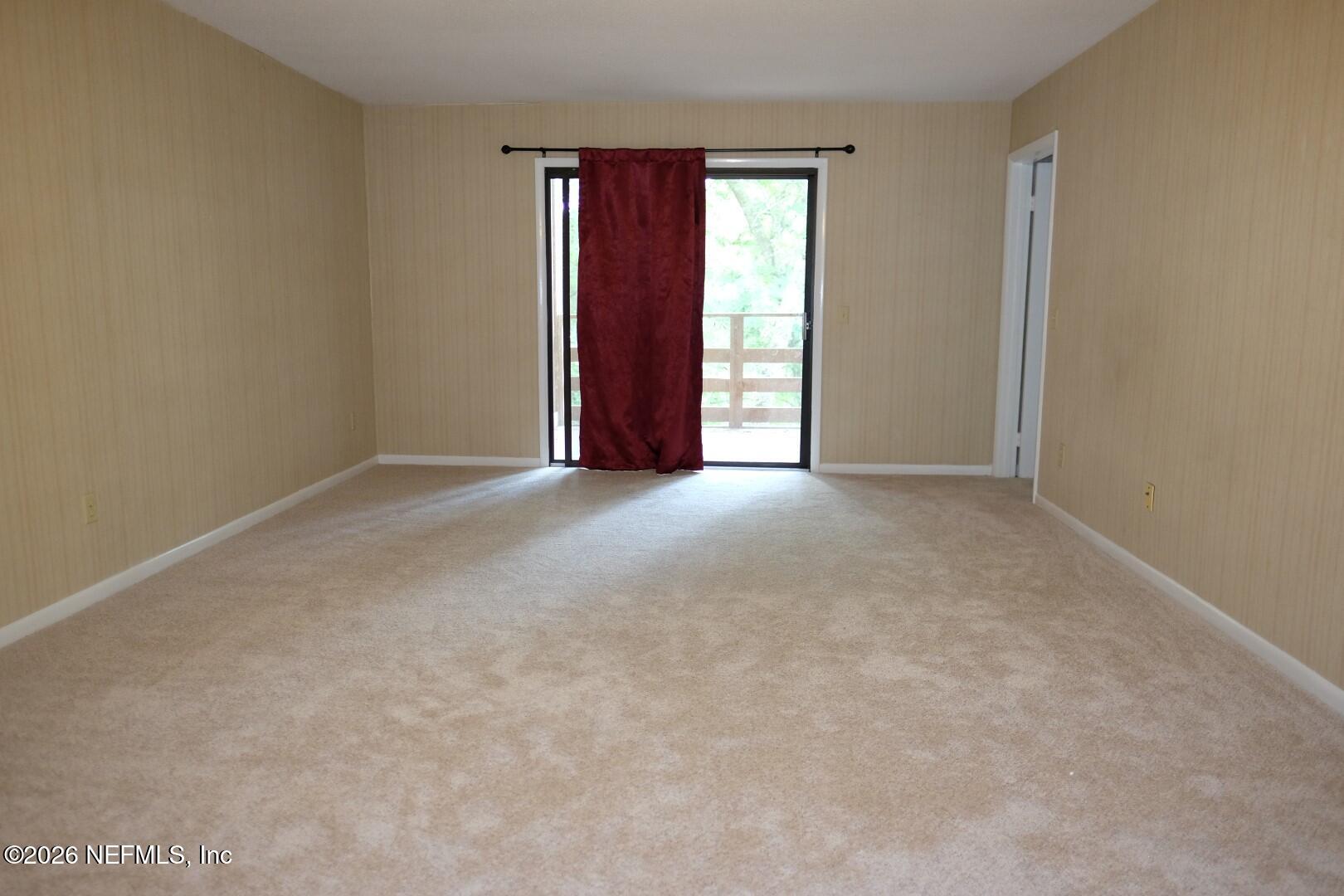 2328 Sadler Road, Unit 7D Fernandina Beach, FL 32034 - Photo 3 of 7 an empty room with windows and closet