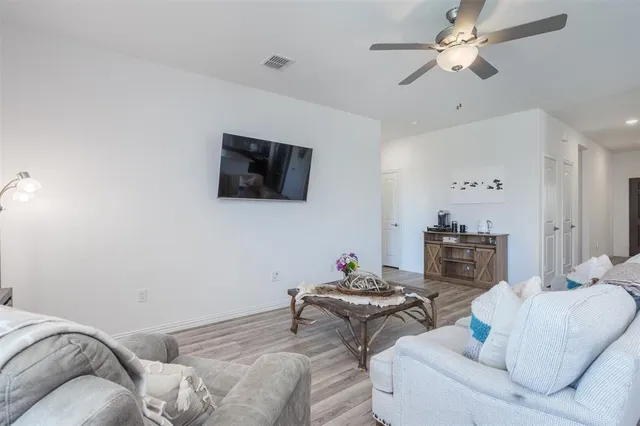a living room with furniture and wooden floor