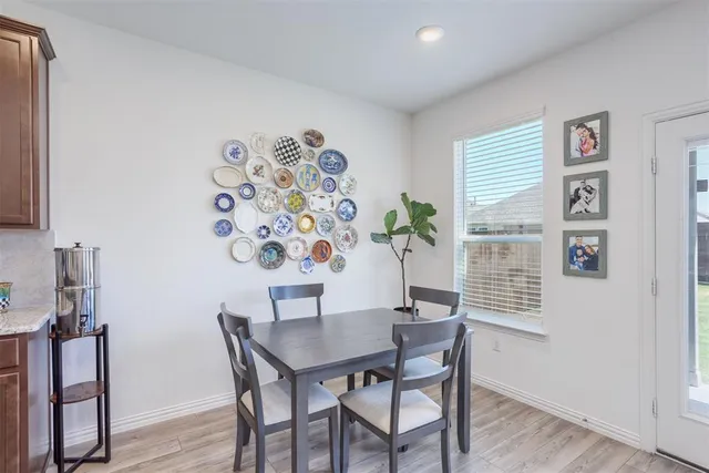 a kitchen with stainless steel appliances granite countertop a sink stove refrigerator and cabinets