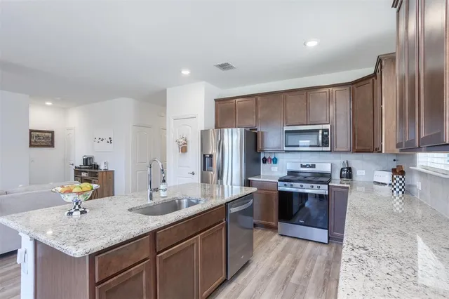 a kitchen with center island table and chairs