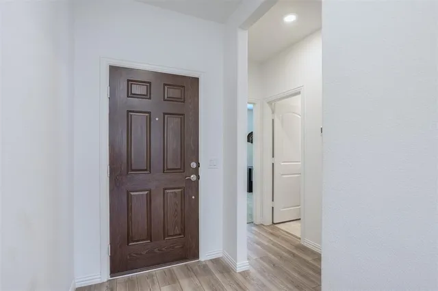 a view of a hallway with wooden floor