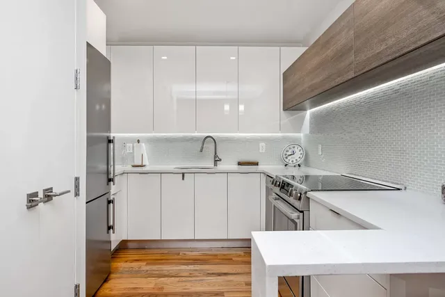 a kitchen with a sink a stove and cabinets