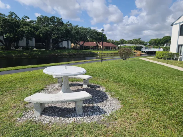a view of a backyard with sitting area