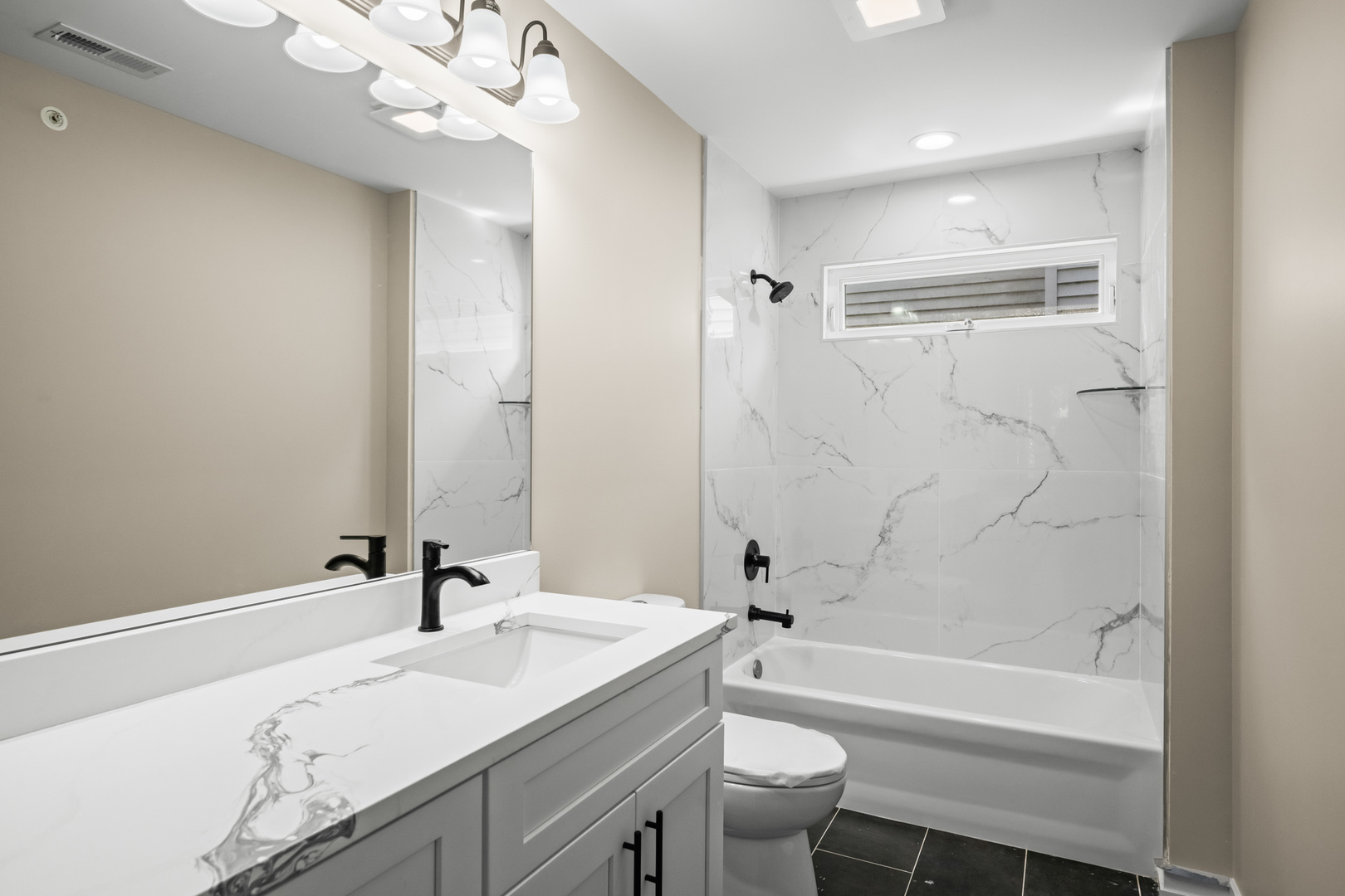 23612 North Field Road Lake Zurich, IL 60047 - Photo 14 of 16 a bathroom with a granite countertop sink a toilet a mirror a bathtub and shower