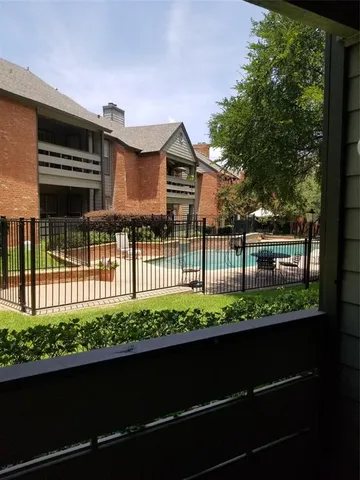a view of a house with a small yard and a large window