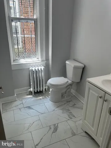 a bathroom with a toilet and a sink