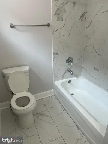 a bathroom with a toilet and a bathtub