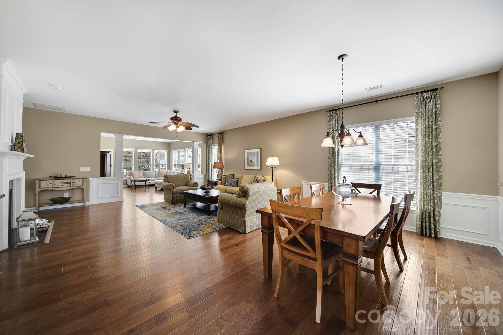 55414 Derringer Avenue Fort Mill, SC 29707 - Photo 11 of 45 a view of a dining room and livingroom with furniture wooden floor a chandelier