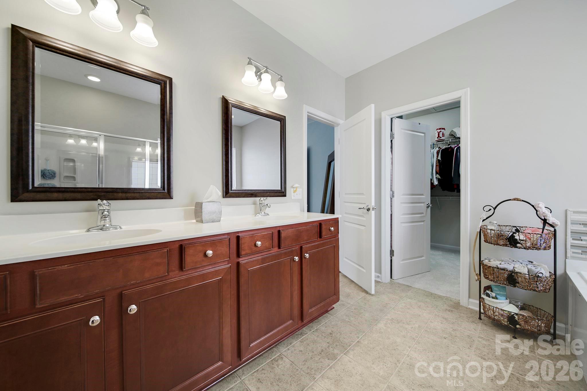55414 Derringer Avenue Fort Mill, SC 29707 - Photo 20 of 45 a en suite bathroom with double vanity sinks and a mirror