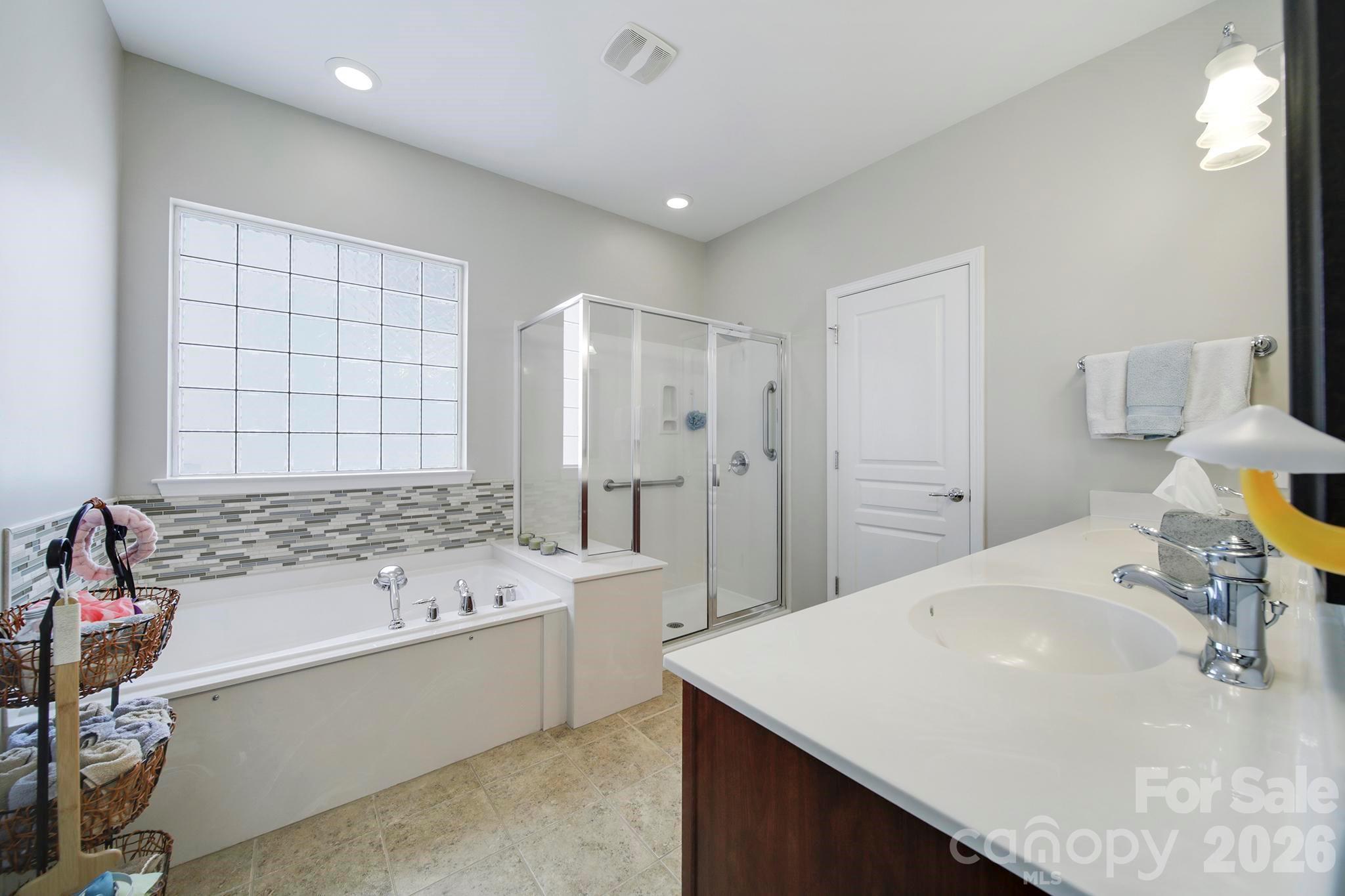 55414 Derringer Avenue Fort Mill, SC 29707 - Photo 21 of 45 a bathroom with a tub sink and mirror