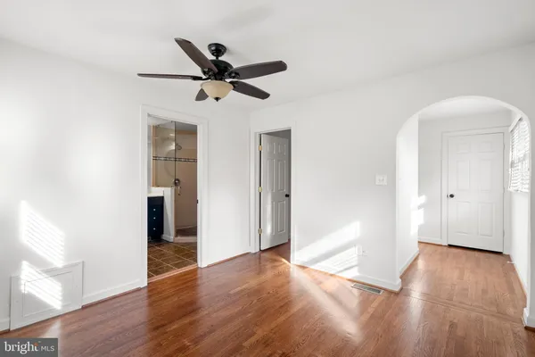 a view of empty room with wooden floor