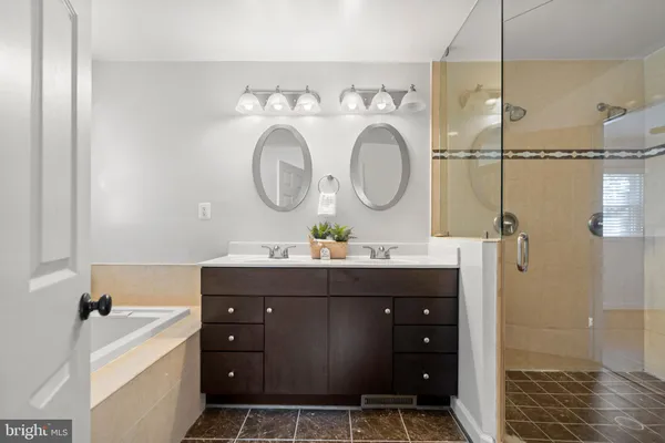 a bathroom with a sink vanity granite and a mirror