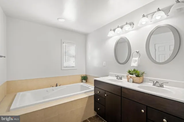 a bathroom with a double vanity sink and a mirror
