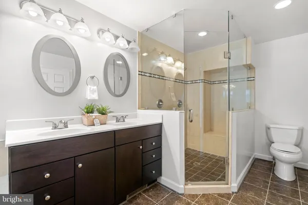 a bathroom with a toilet a sink and a mirror