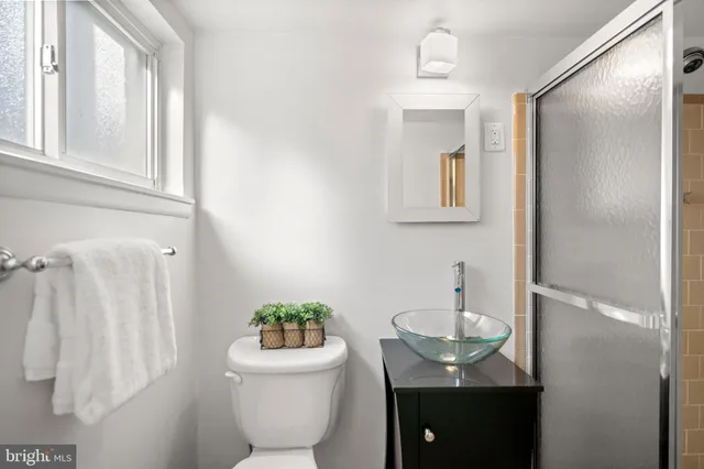 a bathroom with a sink toilet and mirror