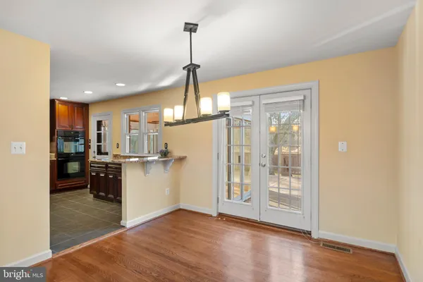 a view of a kitchen and a refrigerator