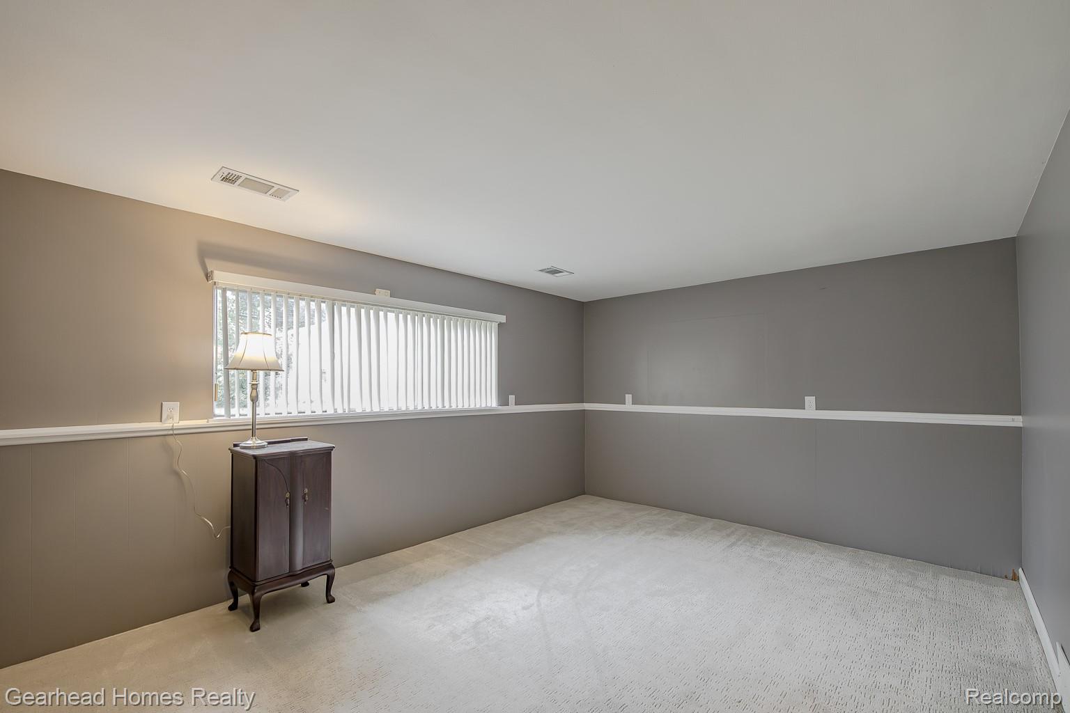 3356 Harding Street Dearborn, MI 48124 - Photo 31 of 48 Spacious room featuring neutral two-tone wall treatment with chair rail detail, recessed ceiling lighting, and plush carpeting throughout