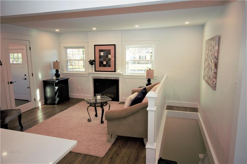 319 Ridge Road Sewickley, PA 15143 - Photo 8 of 25 Open living room with wood burning fireplace, stairwell to basement