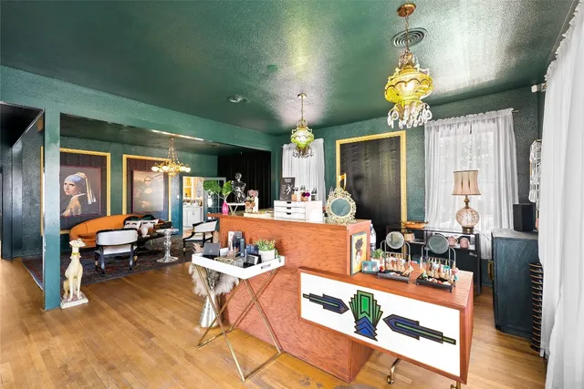 a living room with furniture and a chandelier