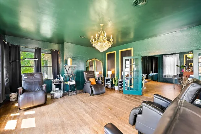 a room with furniture or chandelier and a wooden floor