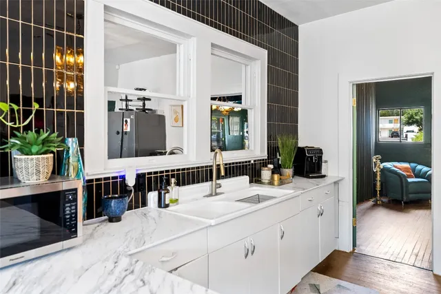 a bathroom with a double vanity sink and a mirror