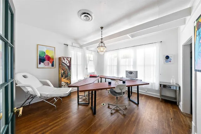 a view of a workspace with furniture and a window