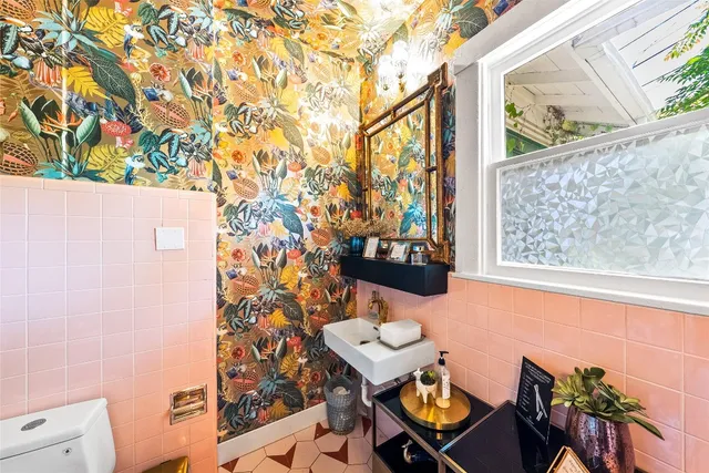 a outdoor view of a house with wooden floor and outdoor seating